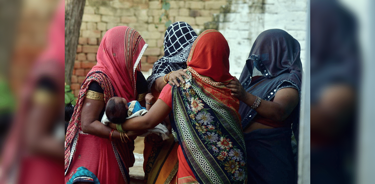 Family members and relatives mourn the death of a 19-year-old woman, who was gang-raped two weeks ago, in Hathras district, Tuesday, Sept. 29, 2020. The Dalit teen died at a hospital in Delhi on Tuesday morning. Credit: PTI Photo