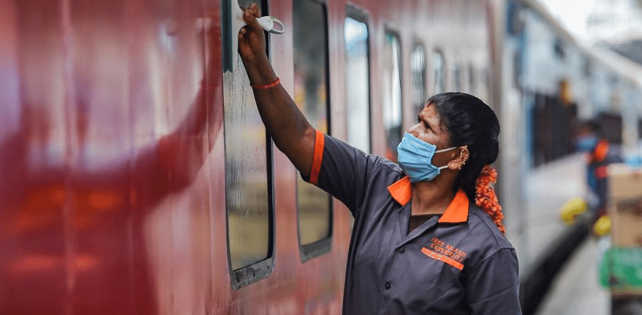 A worker cleans the Chennai -Madurai super fast special train as Southern Railway resumed services after over five months suspension due to Covid-19 outbreak, in Chennai, Monday, Sept. 7, 2020. Credit: PTI Photo