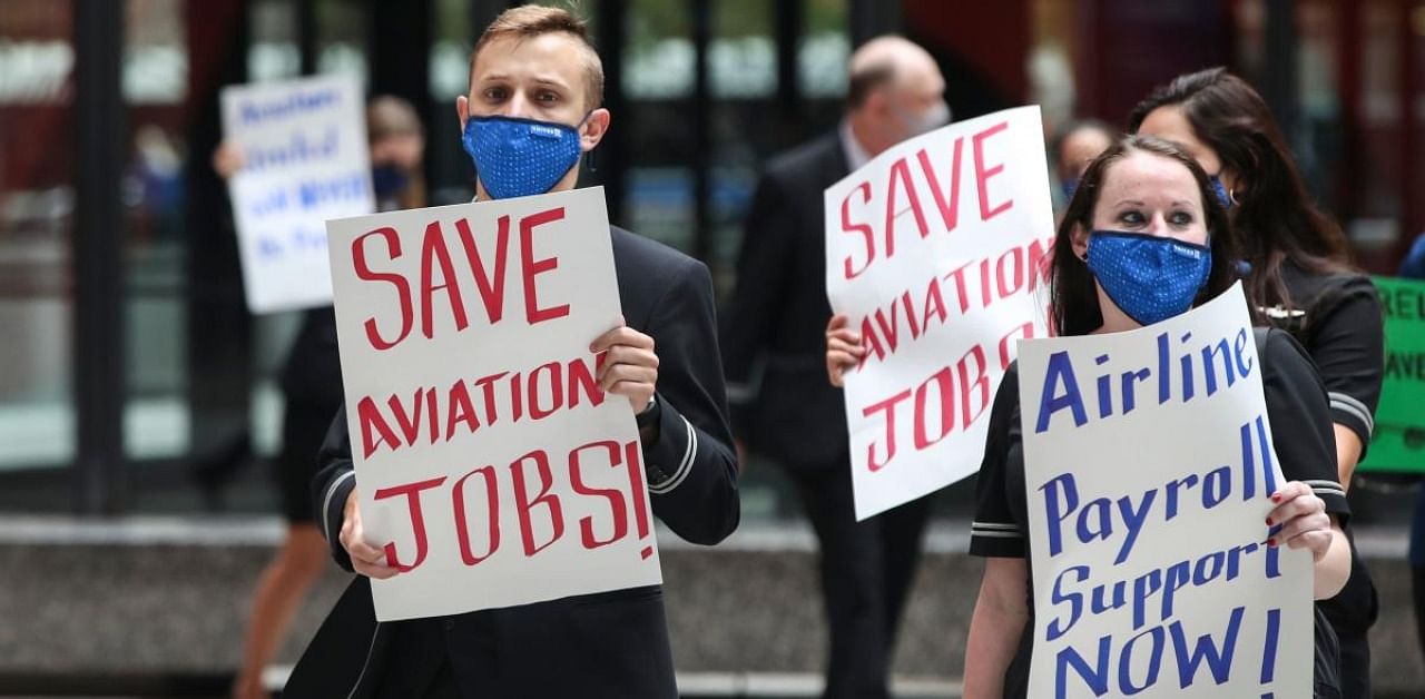 Airline industry workers hold signs during a protest in Federal Plaza in Chicago, Illinois. Credit: AFP