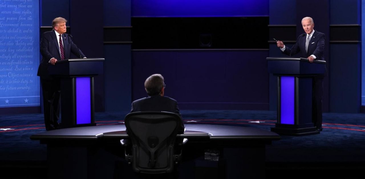 US President Donald Trump and Democratic presidential nominee Joe Biden participate in the first presidential debate moderated by Fox News anchor Chris Wallace (C) at the Health Education Campus of Case Western Reserve University. Credit: AFP