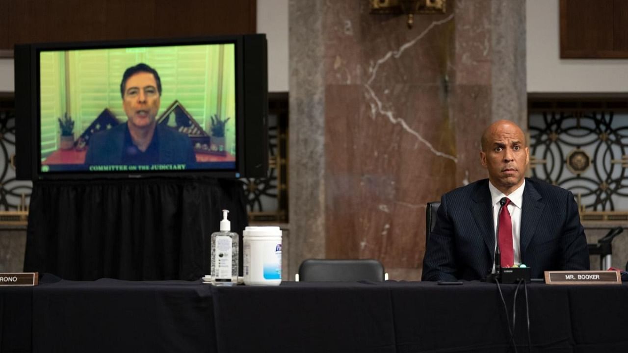 US Senator Cory Booker listens as former FBI Director James Comey virtually testifies during the Senate Judiciary Committee oversight hearing to examine the Crossfire Hurricane Investigation in Washington. Credit: AFP.