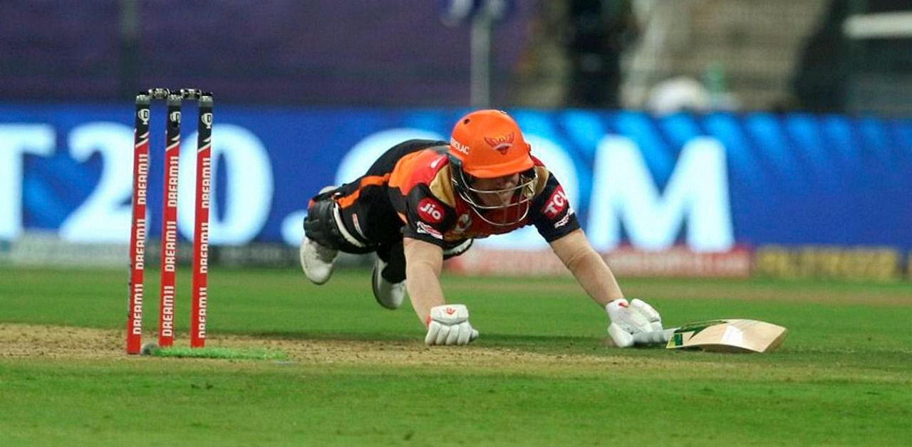 Sunrisers Hyderabad captain David Warner dives to get into the crease during the IPL 2020 cricket match against Delhi Capitals. Credit: PTI Photo