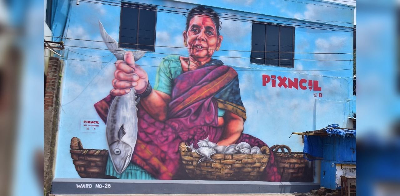 The painting on a fisherwoman selling fish on the wall of a building in Urwa in Mangaluru. DH Photo/Govindraj Javali