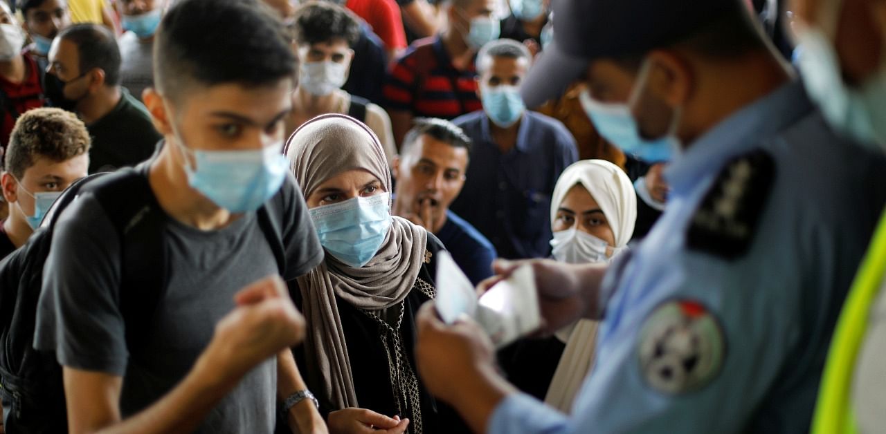 People wearing protective face masks in the southern Gaza Strip. Credit: Reuters Photo