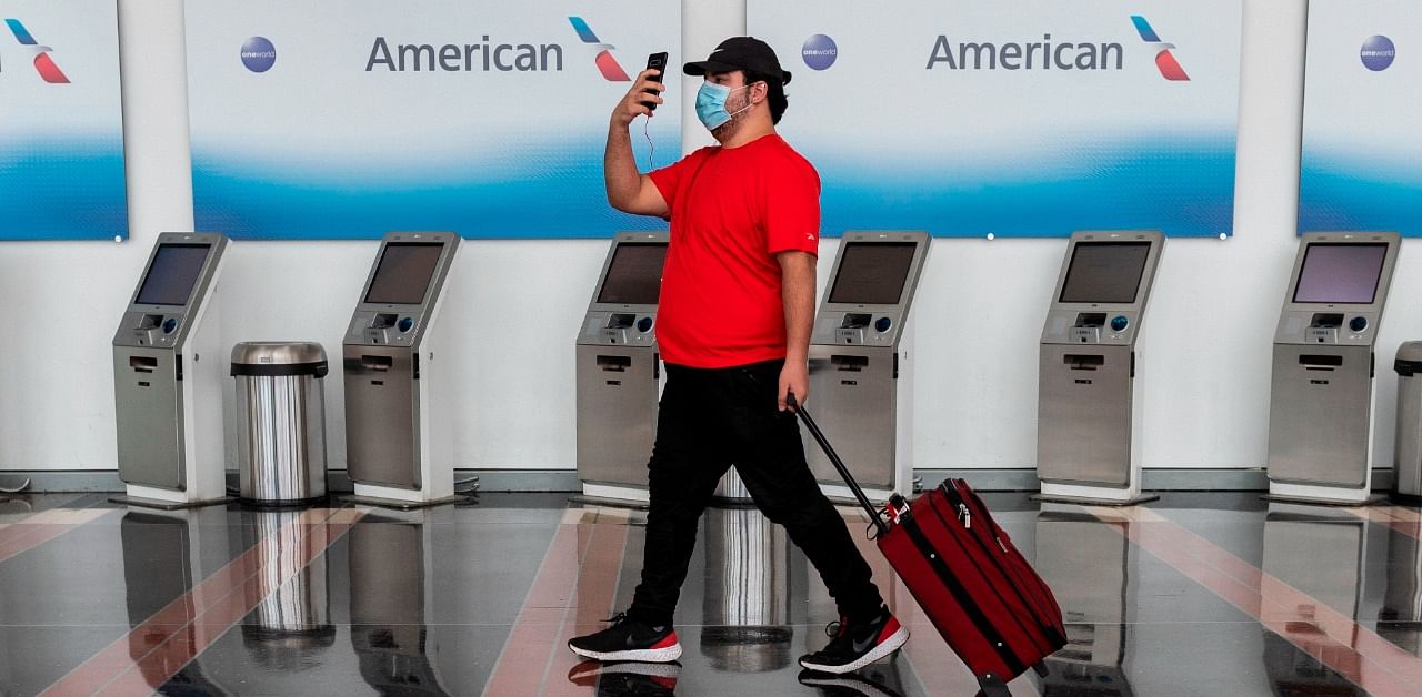 A passenger walks past empty American Airlines check-in terminals at Ronald Reagan Washington National Airport in Arlington, Virginia. Credit: AFP Photo