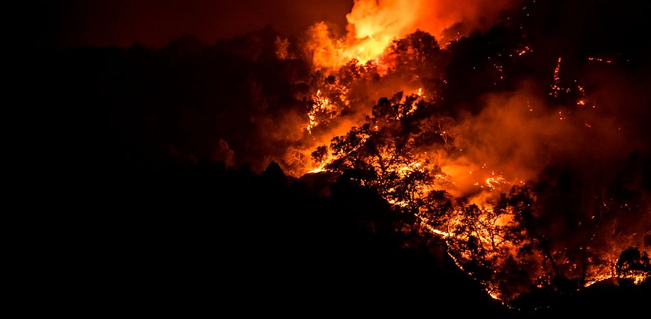 The Glass Fire slowly crests the ridge outside of Calistoga in Napa Valley, California. Credit: AFP Photo