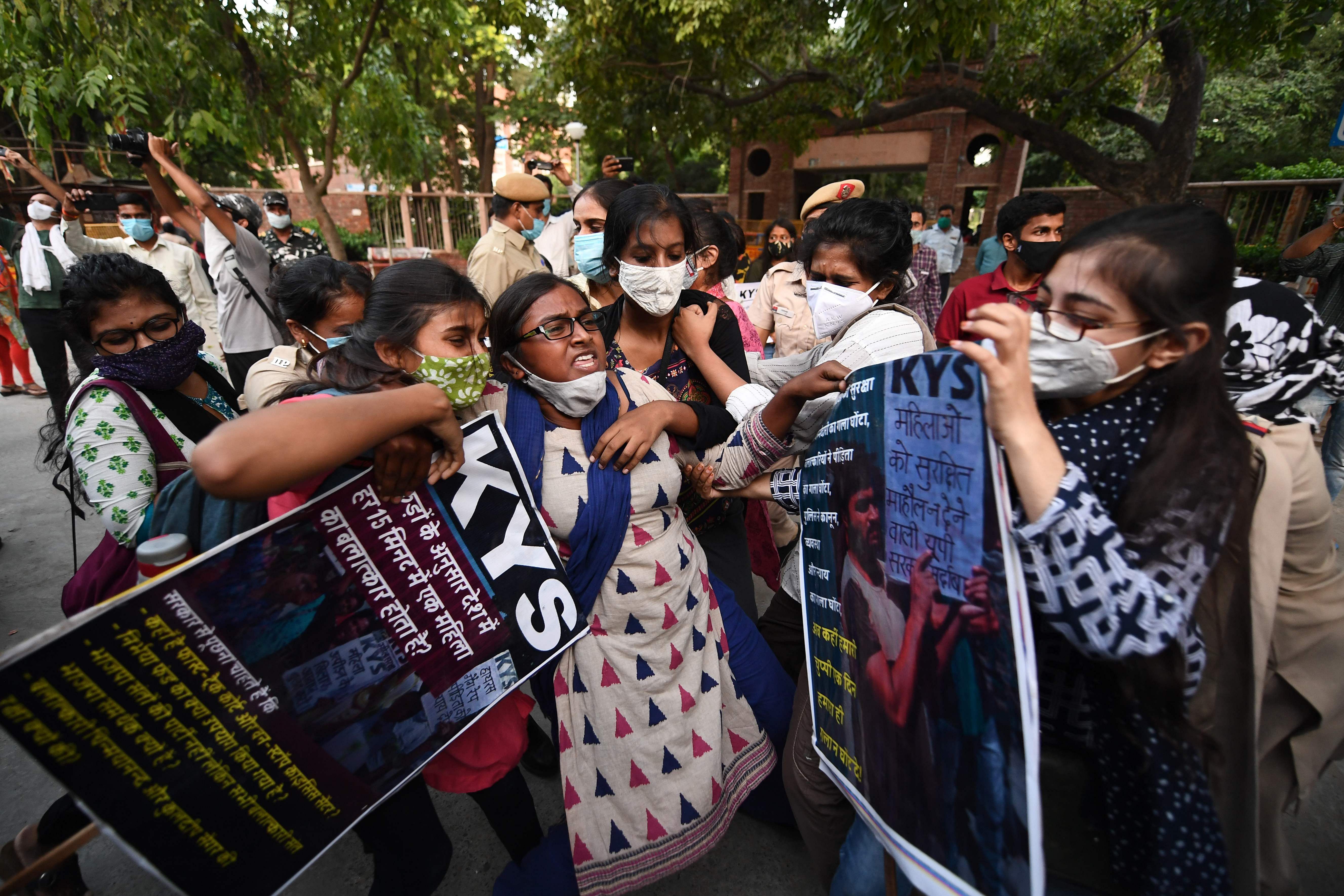 Police personnel detain students during a protest following accusations of Indian Police forcibly cremating the body of a 19-year-old woman victim, who was allegedly gang-raped by four men in Bool Garhi village of Uttar Pradesh state, outside the Delhi University (DU) campus in New Delhi on October 1, 2020. - Indian police were accused on September 30 of forcibly cremating the body of a 19-year-old alleged gang-rape victim as anger grew over the latest horrific sexual assault to rock the country. The teenager from India's marginalised Dalit community suffered serious injuries in a brutal sexual attack two weeks ago, according to her family and police, and died at a New Delhi hospital on September 29. Credit: AFP