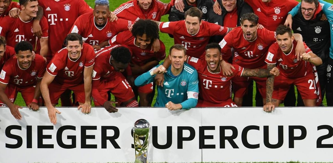 Bayern Munich's German goalkeeper Manuel Neuer and teammates celebrate with the trophy after winning the German Supercup football match FC Bayern Munich v BVB Borussia Dortmund. Credit: AFP
