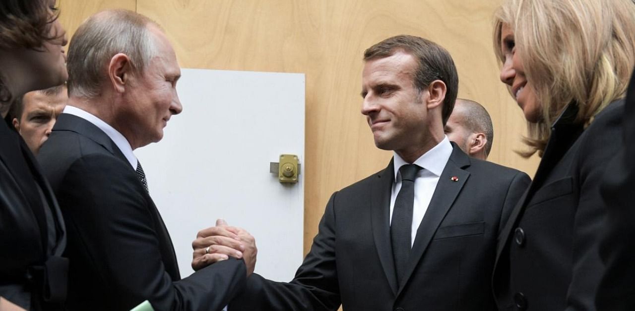  Russian President Vladimir Putin (L) shakes hands with his French counterpart Emmanuel Macron. Credit: AFP