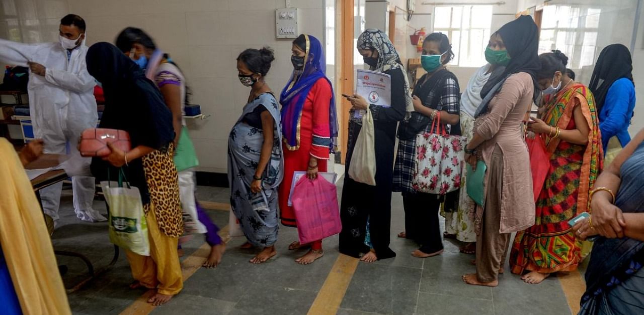 Pregnant women queue to test for the Covid-19 Coronavirus, in Mumbai