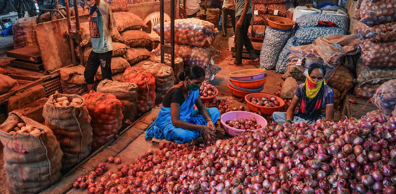 Vegetable vendors sort onions at APMC market, in Navi Mumbai. Credit: PTI Photo