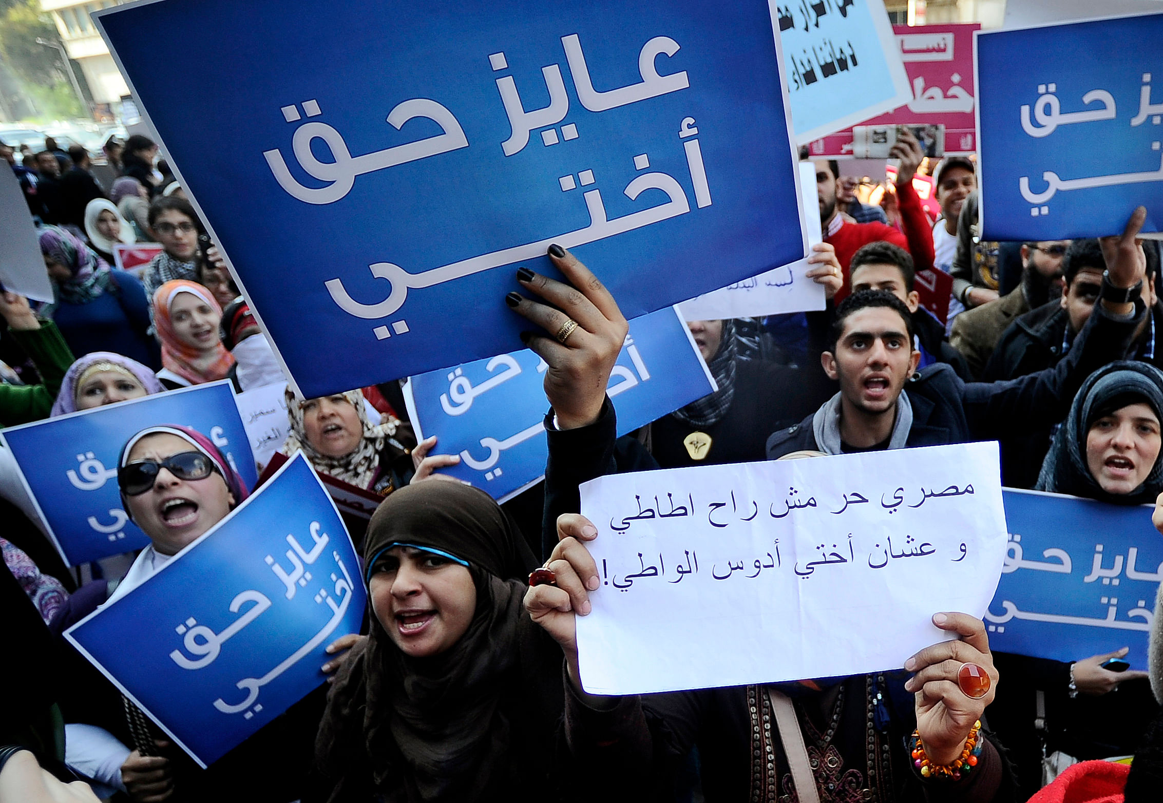 In this file photo taken on December 27, 2011, Egyptian women hold placards that read in Arabic "I want my sister's right" as they protest against the military council violations and virginity tests on women, outside the State Council court in Cairo. - A climate of fear has enveloped Egypt's resurgent #MeToo movement, as the arrest of witnesses in a high-profile gang-rape case threatens to halt the campaign against male sexual violence. A group of nine men from wealthy families are suspected of drugging and gang-raping a young woman in a luxury Cairo hotel and circulating a video of their actions. The attack allegedly took place in 2014 but the allegations only emerged online in July and a complaint was filed in early August. Credit: AFP