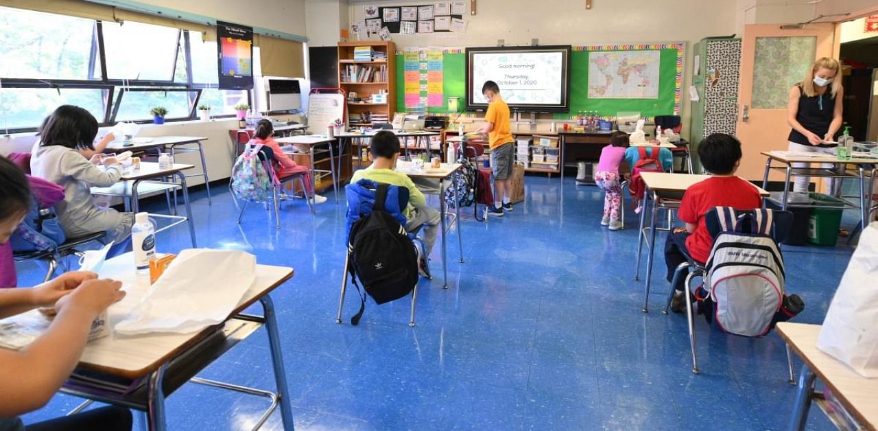 Emily Valentine, a teacher at Yung Wing School teaches students attending class in person on October 01, 2020 in New York City. Credit: AFP