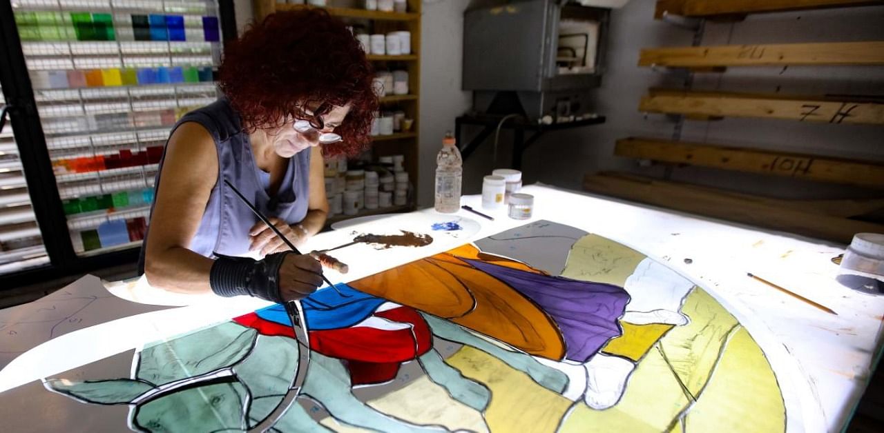 Lebanese stained glass artist Maya Husseini, 60, works on a piece for a cathedral under construction in Jordan. Credit: AFP