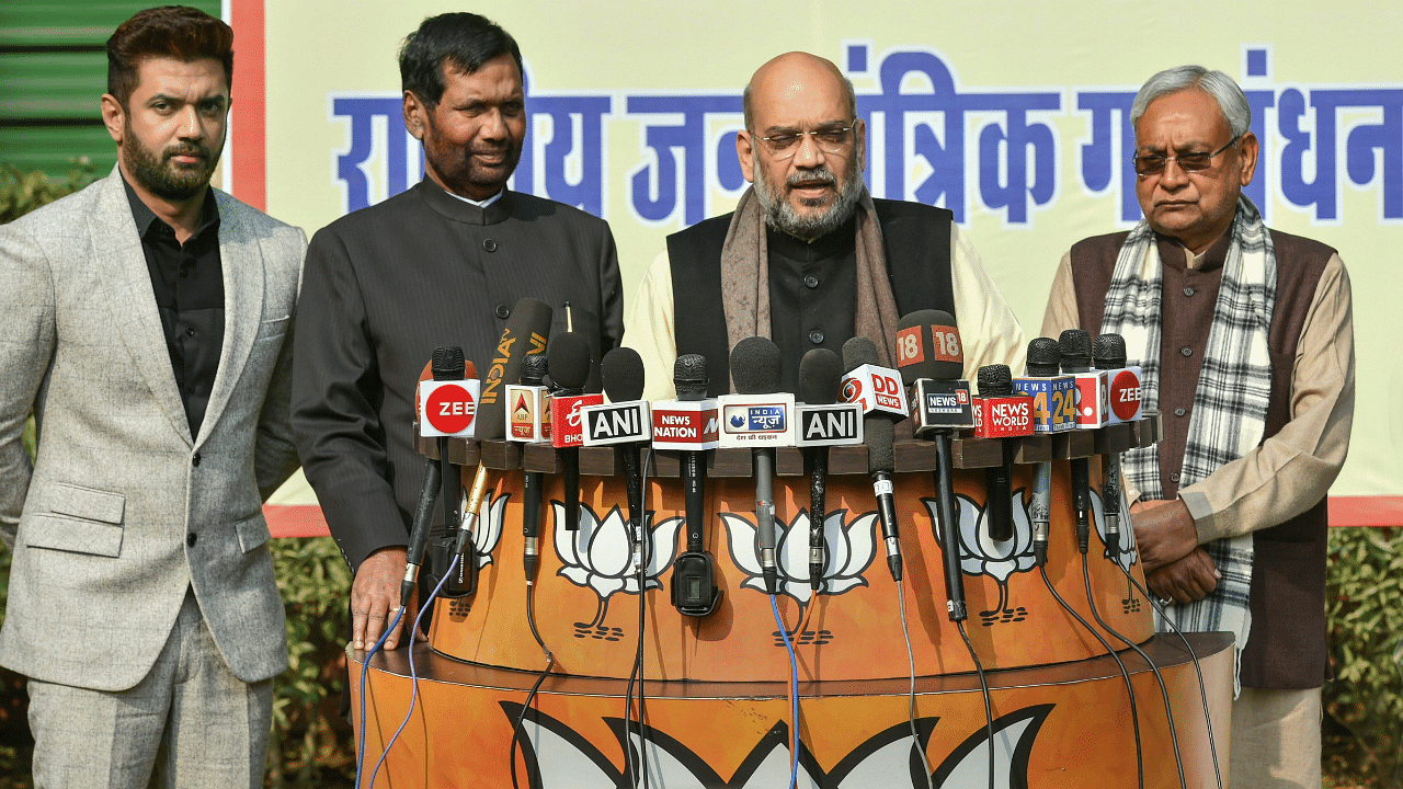 BJP President Amit Shah, JD (U) Chief and Bihar Chief Minister Nitish Kumar, Union minister and LJP President Ram Vilas Paswan with his son and party MP Chirag Paswan. Credits: PTI Photo