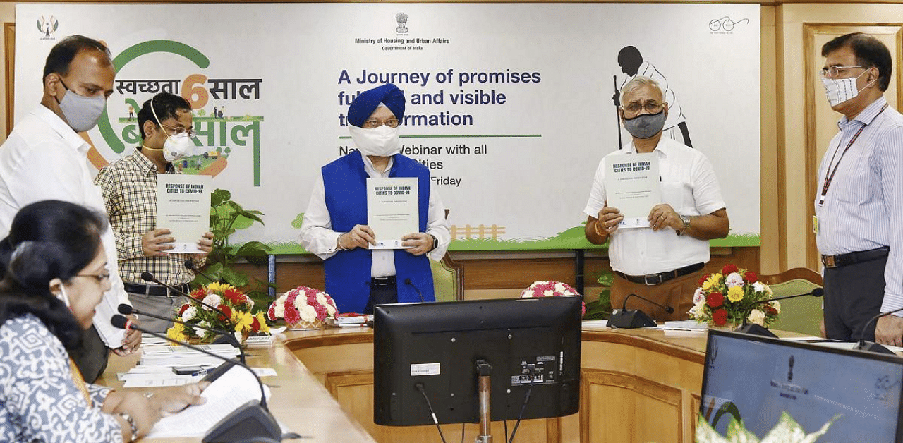 Hardeep Singh Puri releases a publication at a Webinar - Swachh Bharat Mission, to celebrate the 6th Anniversary of SBM-Urban, in New Delhi. Credit: PTI Photo