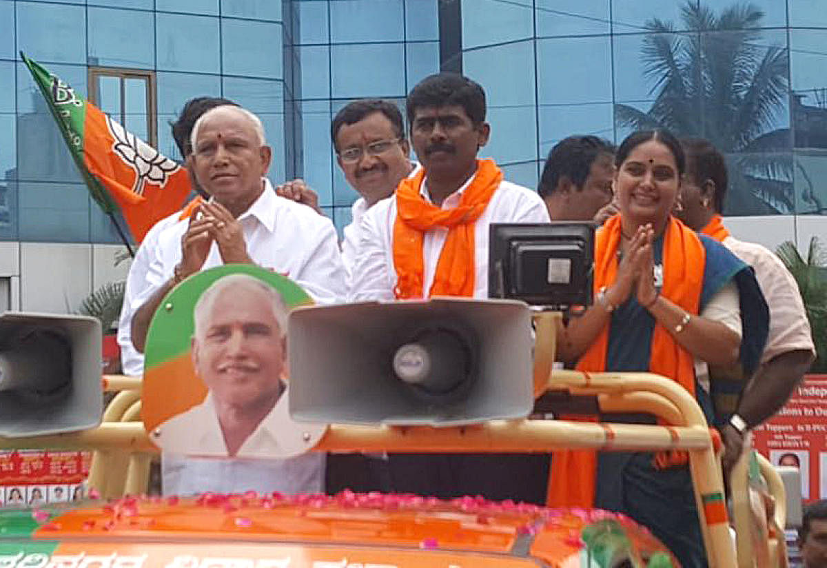A DH file photo of BJP state president B S Yeddyurappa campaigning for RR Nagar party candidate Muniraju Gowda (centre) in Rajarajeswari Nagar constituency. Actor Shruti is also seen.