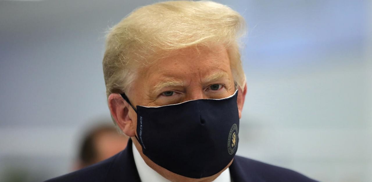 US President Donald Trump wears a protective face mask. Credit: Reuters