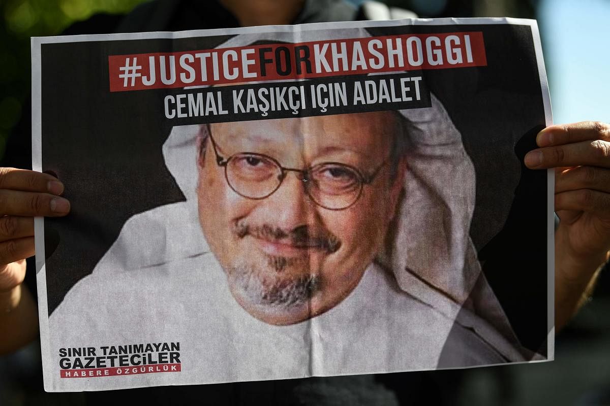 Friends of murdered Saudi journalist Jamal Khashoggi hold posters bearing his picture as they attend an event marking the second-year anniversary of his assassination in front of Saudi Arabia Istanbul Consulate. Credit: AFP