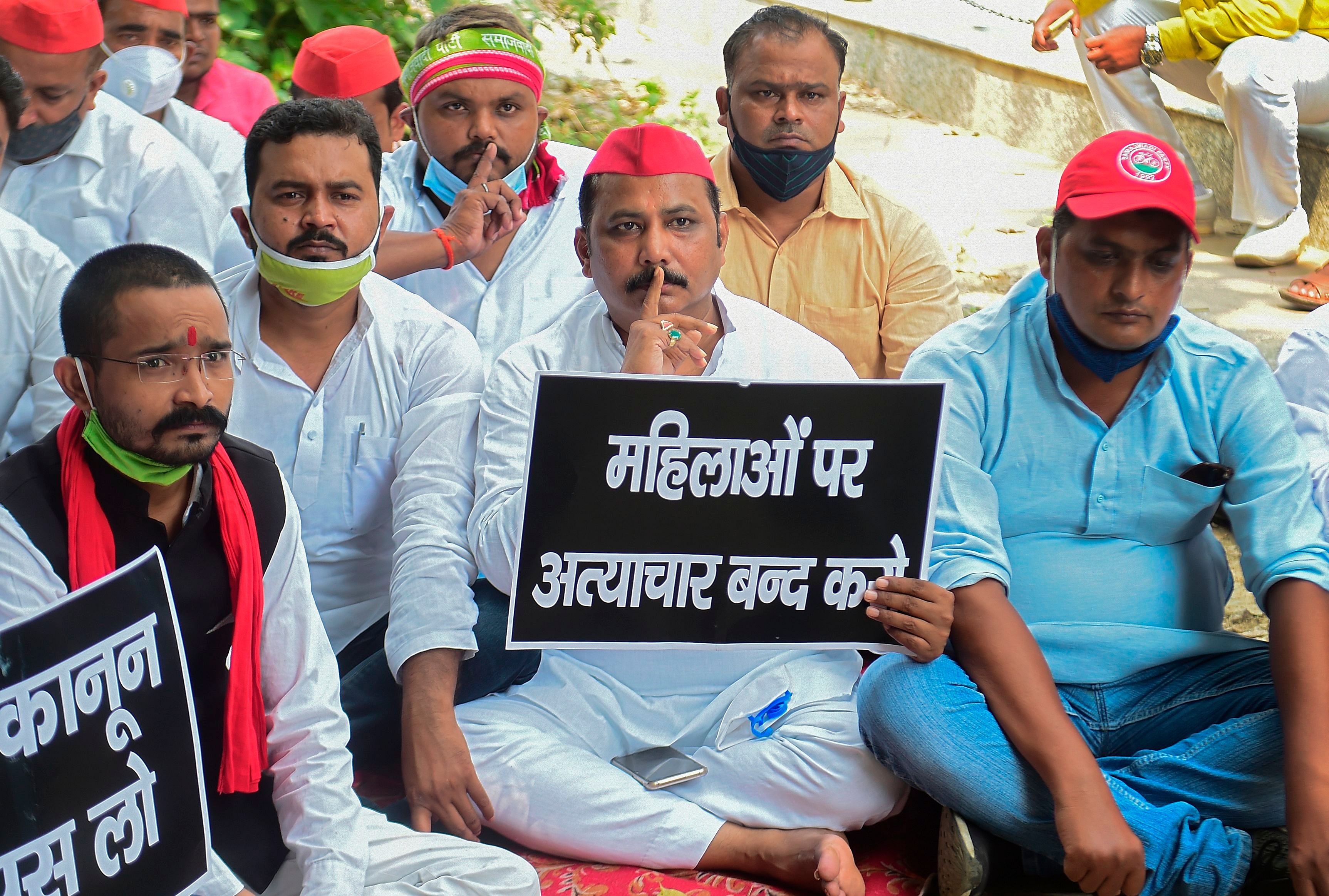 Supporters of the Samajwadi party during a silent protest against the alleged gang-rape of a 19 year-old woman by four men in Bool Garhi village of Uttar Pradesh state and various issues, in Allahabad on October 2, 2020. . - Indian police have been ordered to provide protection to the "untouchable" family of a woman allegedly gang-raped and killed by four upper-caste men, as her brother said they feared for their lives. The 19-year-old was attacked in mid-September and died this week, sparking outrage and shining the spotlight again on the alarming levels of sexual violence against Indian women, particularly if they are low-caste.Credit: AFP