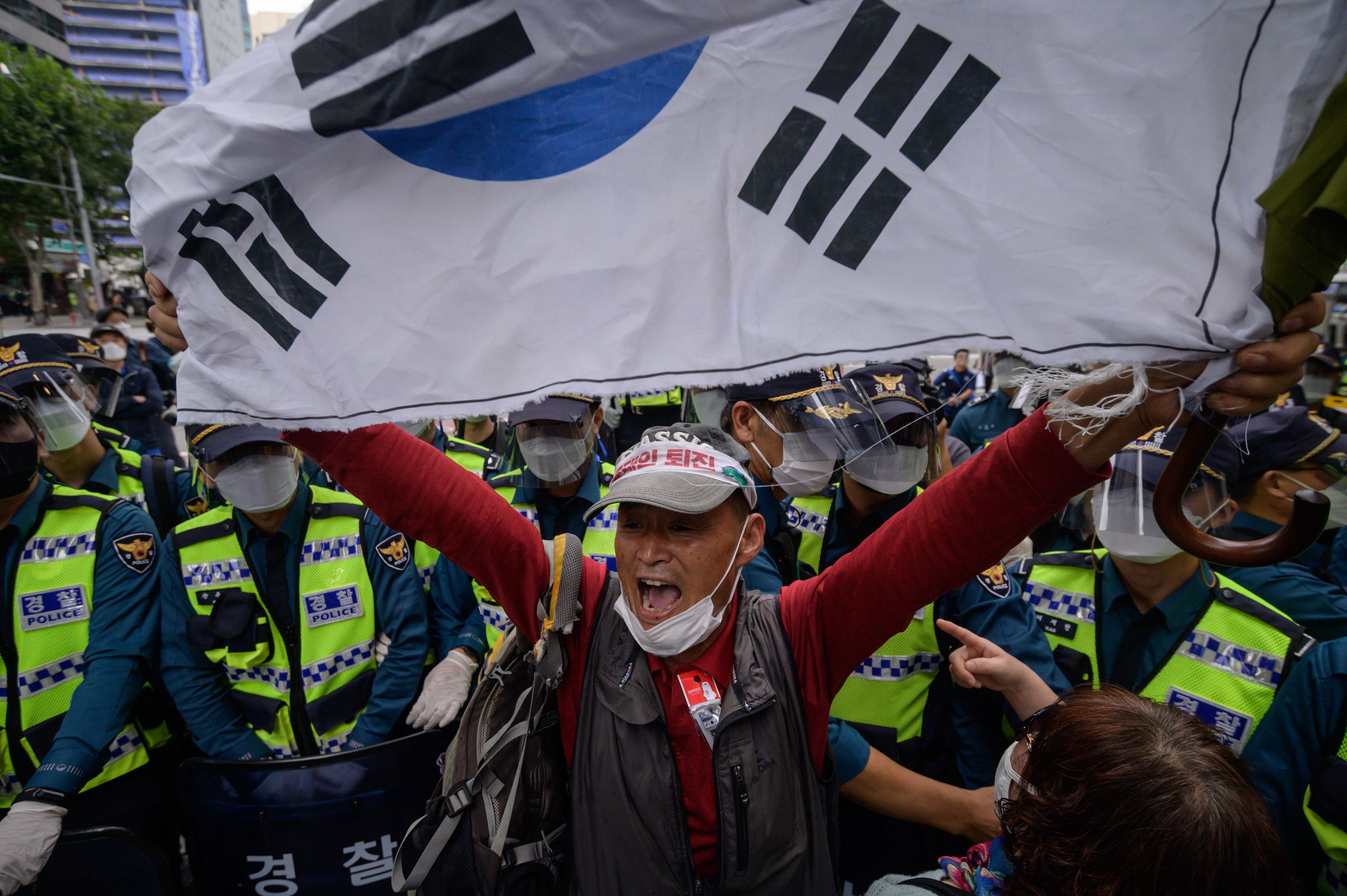 A conservative anti-government protester shouts slogans during an attempted rally in the central Gwanghwamun district of Seoul as South Korea marks 'Foundation Day' on October 3, 2020. - Conservative groups had planned to hold anti-govenment rallies throughout central Seoul, which were banned by police due to concerns over the spread of the covid-19 coronavirus. Credit: AFP