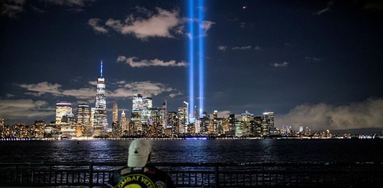 A man looks at The Tribute in Light installation from Liberty State Park, marking the 19th anniversary of the 9/11 attacks in New York City. Credit: Reuters