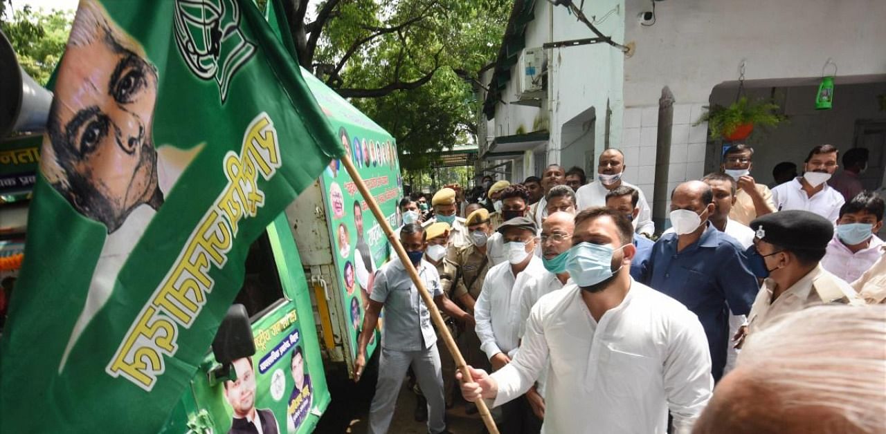 RJD leader Tejashwi Yadav flags off a van during an election campaign ahead of the Bihar assembly polls, at party office in Patna. Credit: PTI