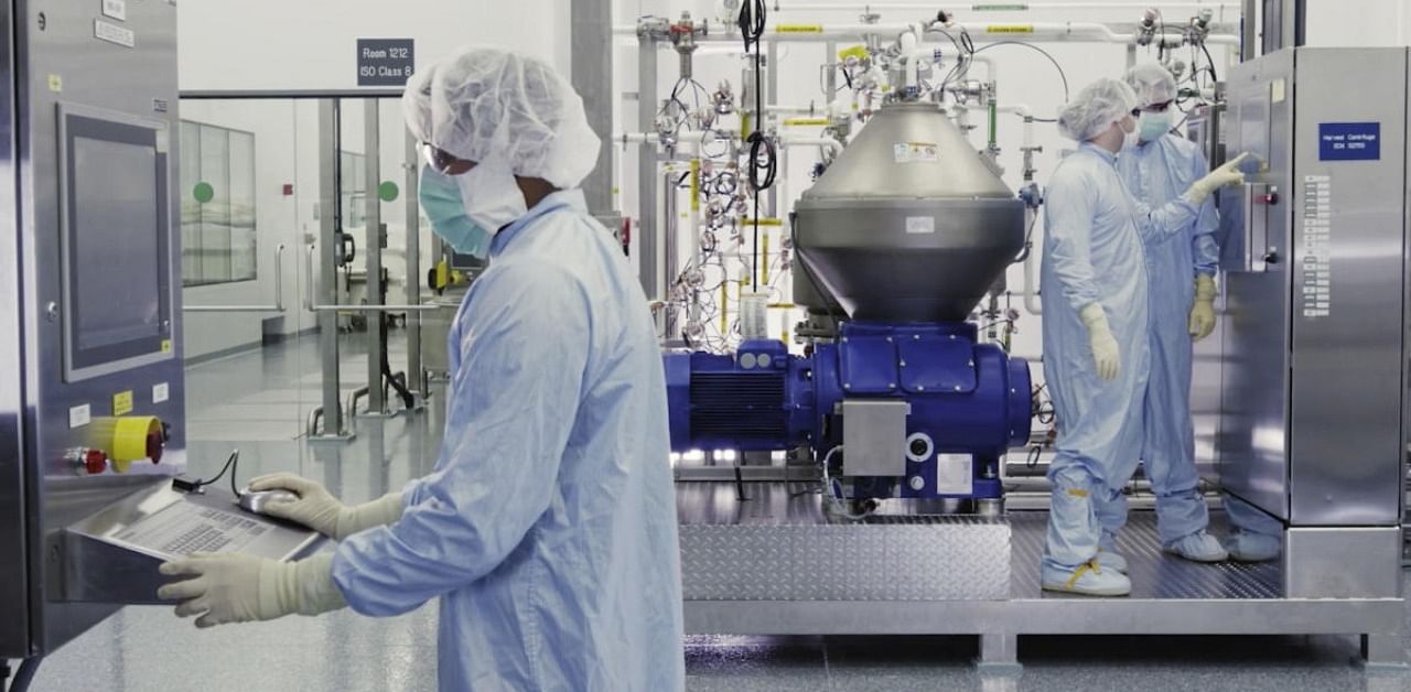 Regeneron Pharmaceuticals scientists work with a bioreactor at a company facility in New York state, for efforts on an experimental coronavirus antibody drug. Antibodies are proteins the body makes when an infection occurs; they attach to a virus and help the immune system eliminate it. Credit: AP