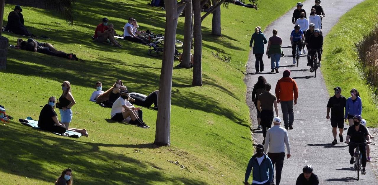 People exercise at a park along the Yarra River in Melbourne. Credit: AFP