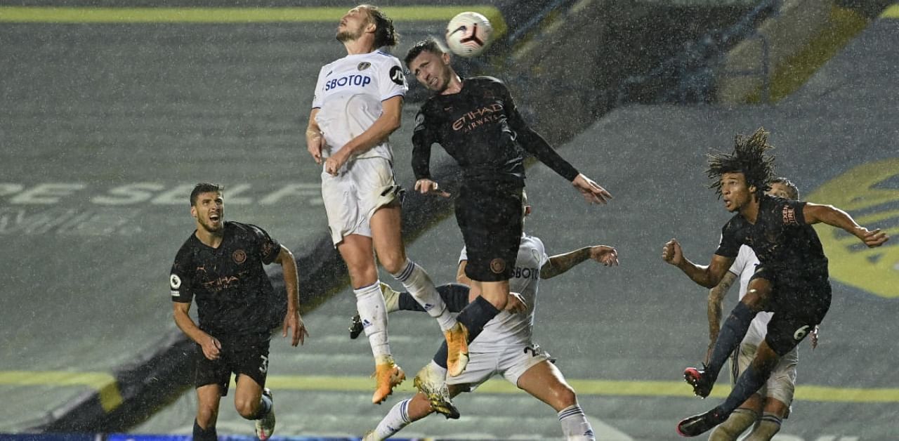 Leeds United's Luke Ayling, 2nd left, jumps for the ball during the English Premier League soccer match between Leeds United and Manchester City at Elland Road in Leeds, England. Credit: AP