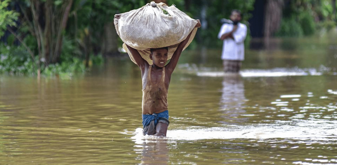  A boy wades through a flooded area, following heavy rainfall, in Nagaon district, Sept. 25, 2020. Credit: PTI Photo