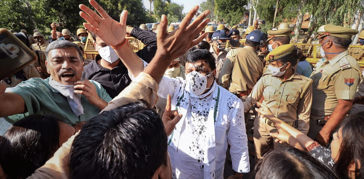 An unknown person threw ink at Aam Aadmi Party (AAP) MP Sanjay Singh in Hathras, Uttar Pradesh where he had gone to meet the family of the 19-year-old who was allegedly gang-raped last month. Credit: PTI Photo