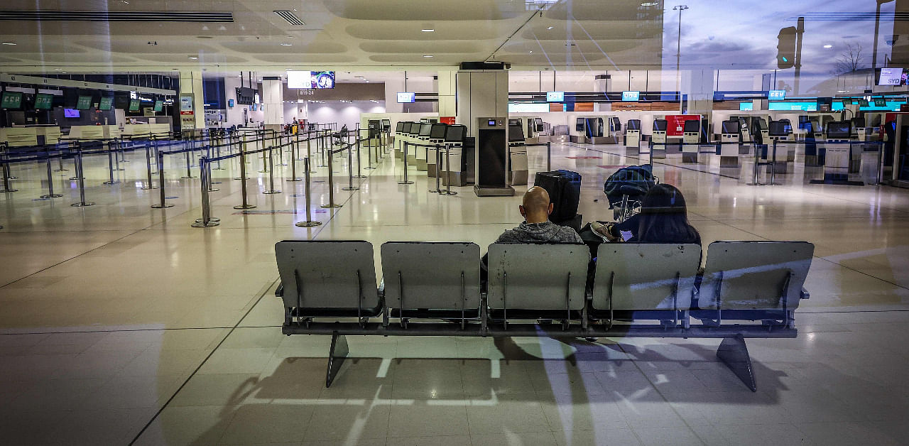 This picture taken on September 29, 2020 shows passengers waiting to check in for their flight in the departures area of the Sydney International Airport in Sydney. Credit: AFP Photo
