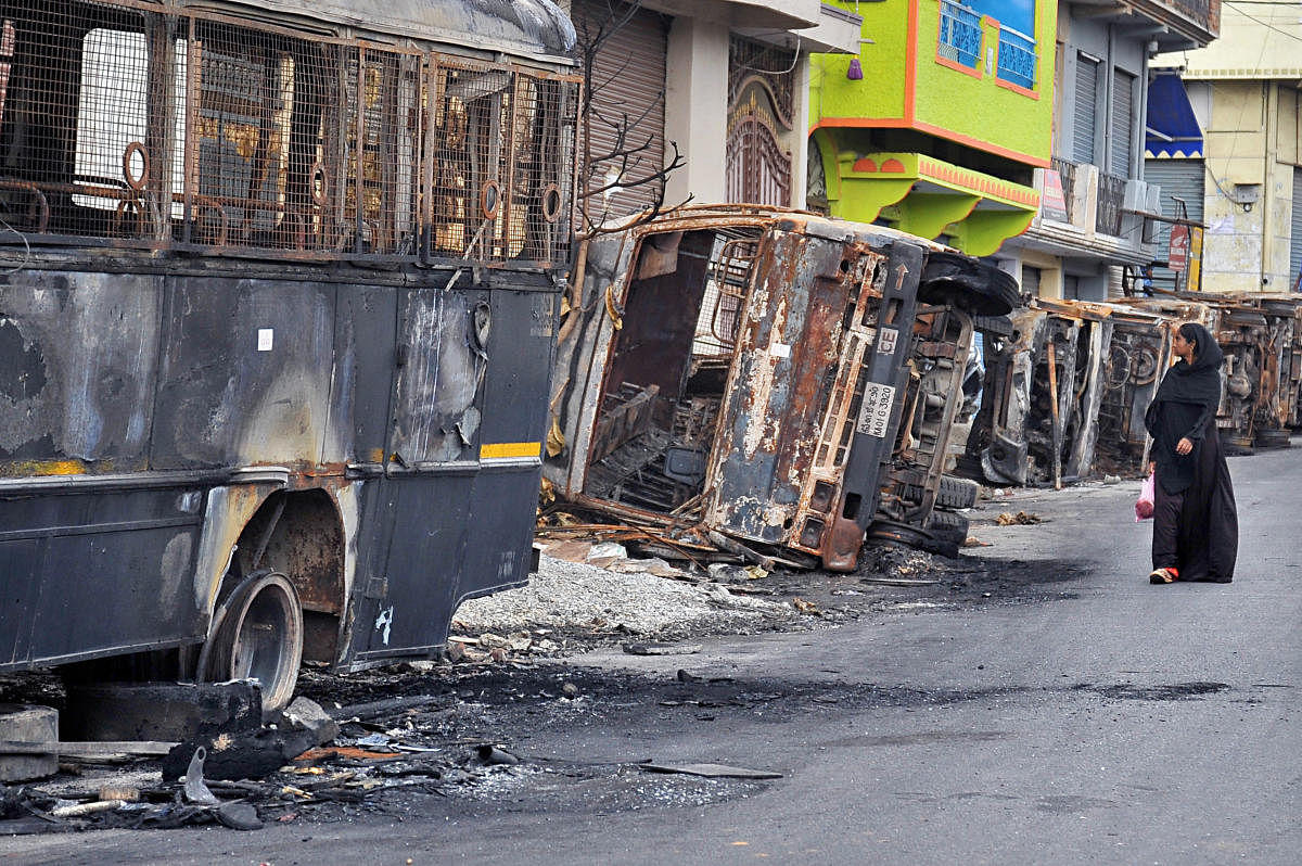 Scores of government vehicles were torched during the riots that broke out on August 11. DH FILE/Pushkar V
