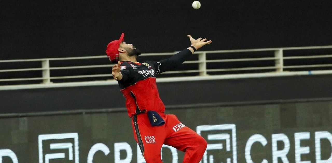 Royal Challengers Bangalore (RCB) captain Virat Kohli attempts to catch the ball during IPL 2020 cricket match. Credit: PTI