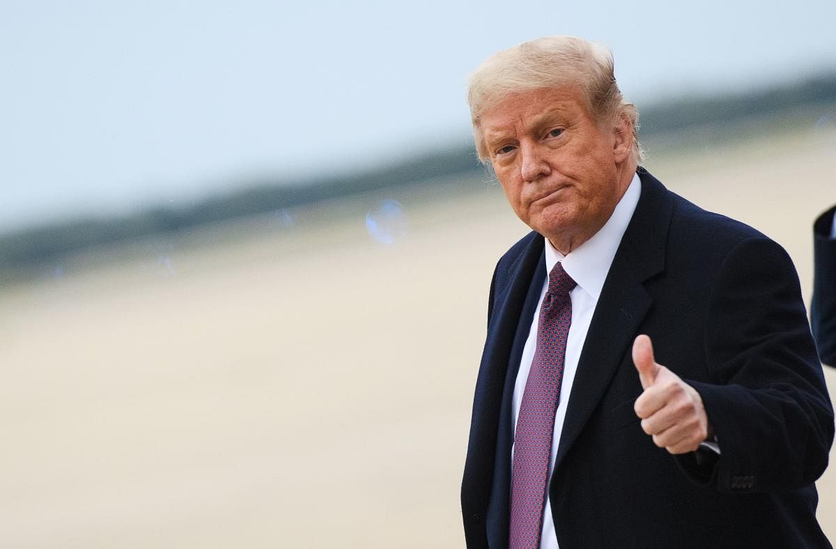 In this file photo US President Donald Trump gives a thumbs up as he steps off Air Force One upon arrival at Andrews Air Force Base in Maryland on October 1, 2020. 