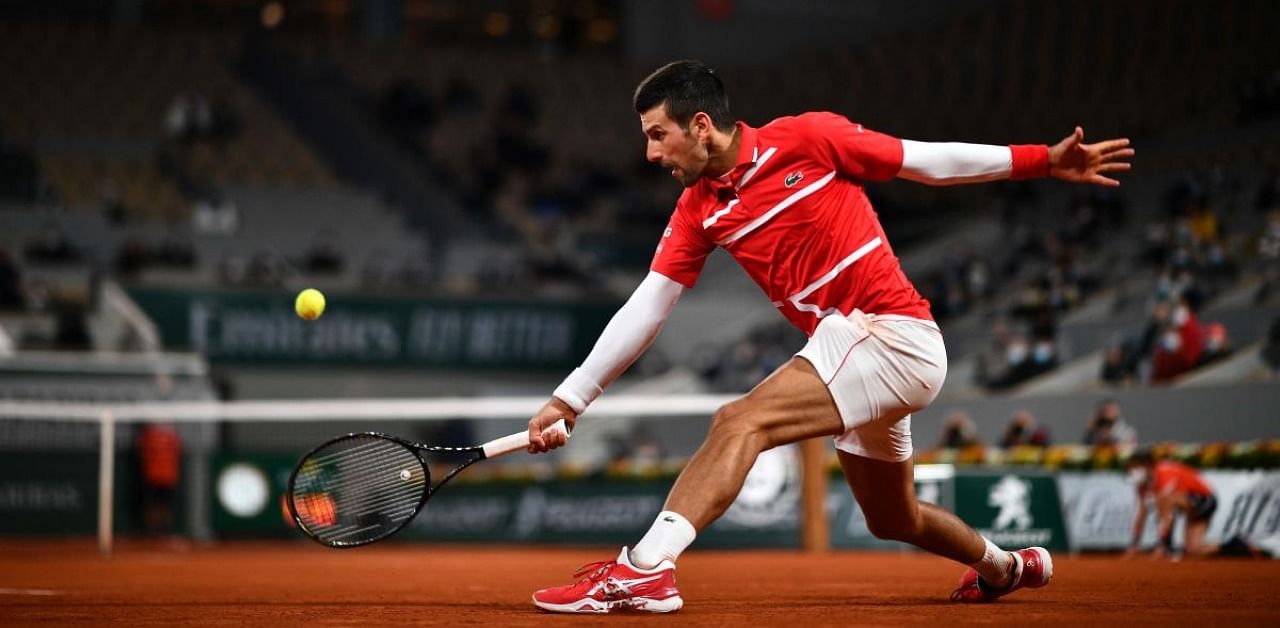 Serbia's Novak Djokovic returns the ball to Russia's Karen Khachanov during their men's singles fourth round tennis match on Day 9 of The Roland Garros 2020 French Open tennis tournament in Paris on October 5, 2020. Credit: AFP Photo