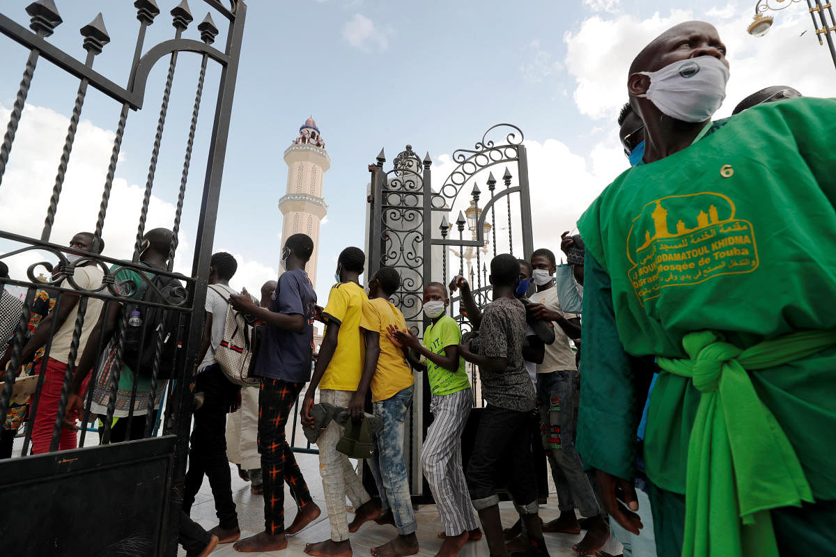 People queue to enter the Great Mosque as hundreds of thousands of the Senegalese Mouride Brotherhood pilgrims gather for the annual Grand Magal festival. Credit: Reuters