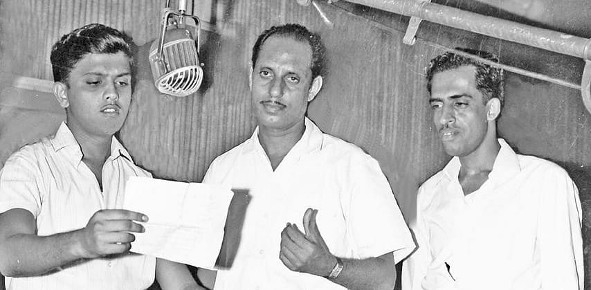 Nagesh Babu discusses a point with playback singer SP Balasubrahmanyam and music director Vijay Bhaskar while recording a song for Anireekshita Kannada film. Babu produced and directed the film. Credit: Special Arrangement
