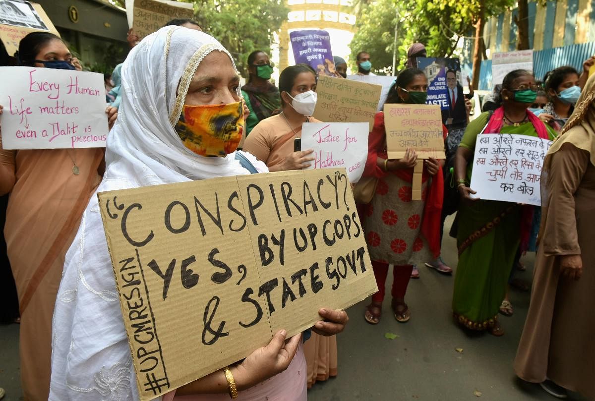 Activists hold placards during a protest against the death of a 19-year-old Dalit woman who was allegedly gang-raped two weeks ago in Hathras (UP), outside Chaitya Bhoomi in Mumbai, Tuesday, Oct. 6, 2020. Credit: PTI Photo
