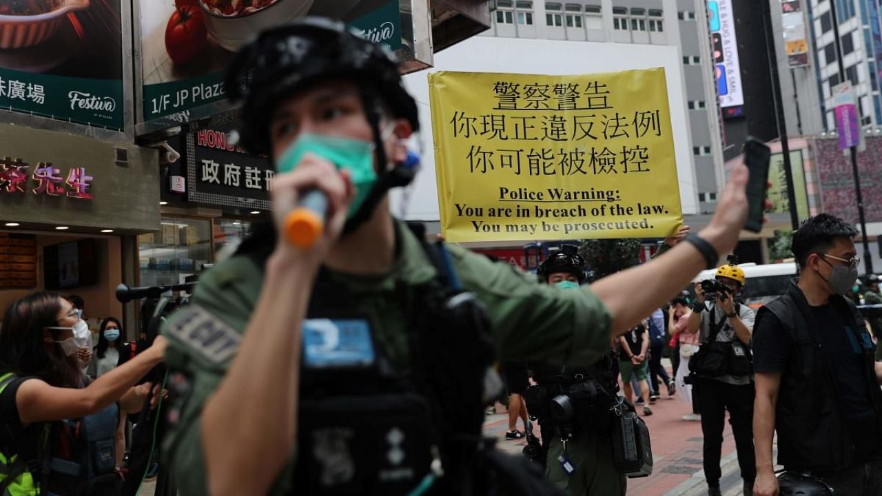 Police hold a yellow banner during China's National Day in Hong Kong on October 1, 2020, which commemorates the 71st anniversary of the establishment of the People's Republic of China. Credit: AFP