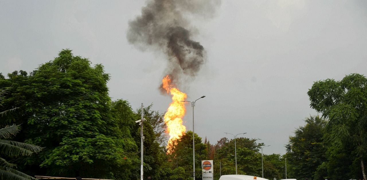 Flames rise from the Indian Oil Corporation petrol pump after a fire broke out following an explosion near Raj Bhawan. Credit: PTI Photo