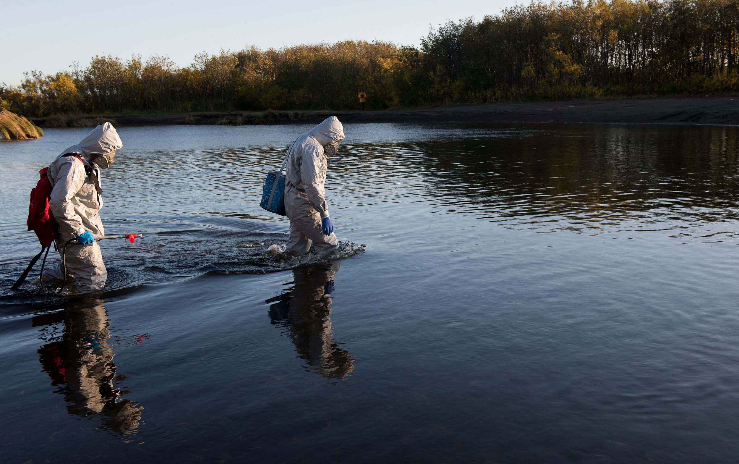 Experts collect water samples during the Greenpeace expedition to inspect territories of Kamchatka peninsula that could be affected by pollution, Russia October 8, 2020. Credit: Greenpeace Russia/Handout via REUTERS