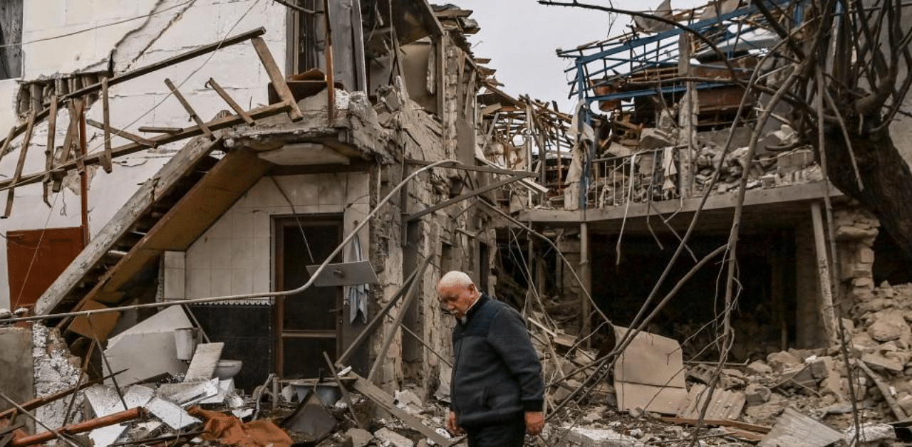 An elderly man stands in front of a destroyed house after shelling in the breakaway Nagorno-Karabakh region's main city of Stepanakert on October 7, 2020, during the ongoing fighting between Armenia and Azerbaijan over the disputed region. Credit: AFP Photo