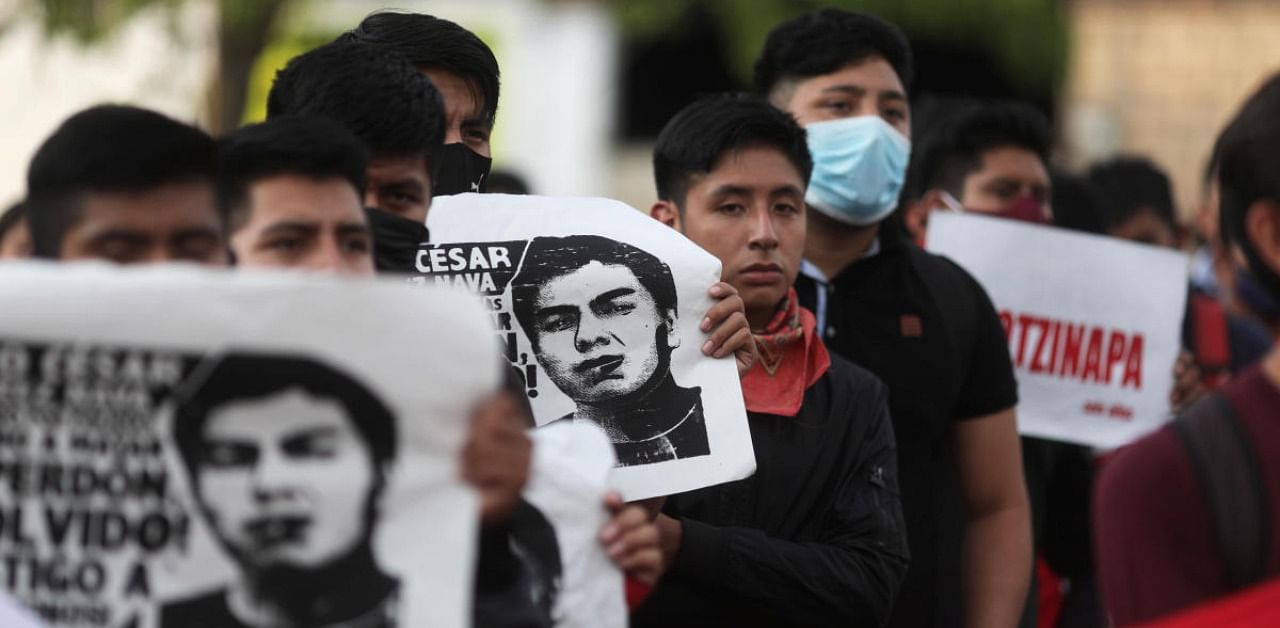 Relatives of missing students hold posters with their images as they take part in a march to mark the sixth anniversary of the disappearance of 43 students of the Ayotzinapa Teacher Training College, in Iguala in the southwestern state of Guerrero, Mexico. Credit: Reuters