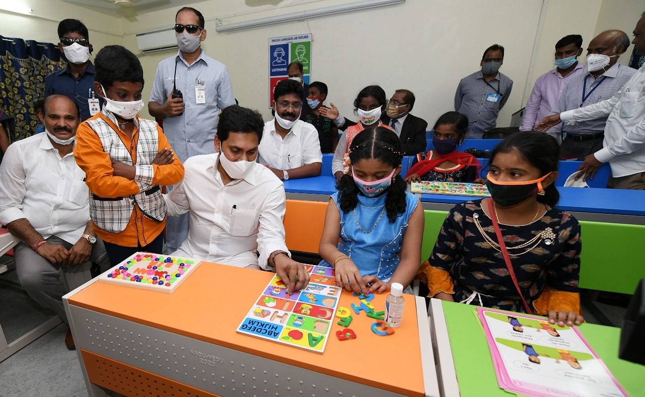 Andhra Pradesh Chief Minister Y S Jaganmohan Reddy on Thursday handed over the kits to the students at a government school at Punadipadu near Vijayawada. Credit: DH Photo