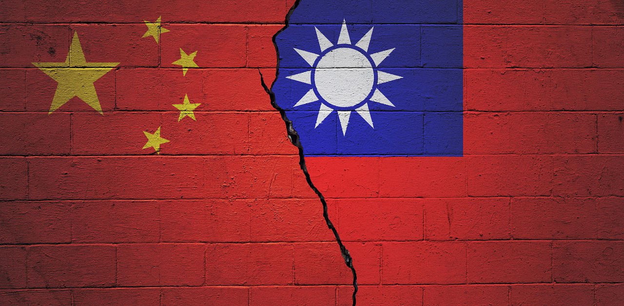 Cracked brick wall painted with an Chinese flag on the left and a Taiwanese flag on the right. Credit: iStockPhoto