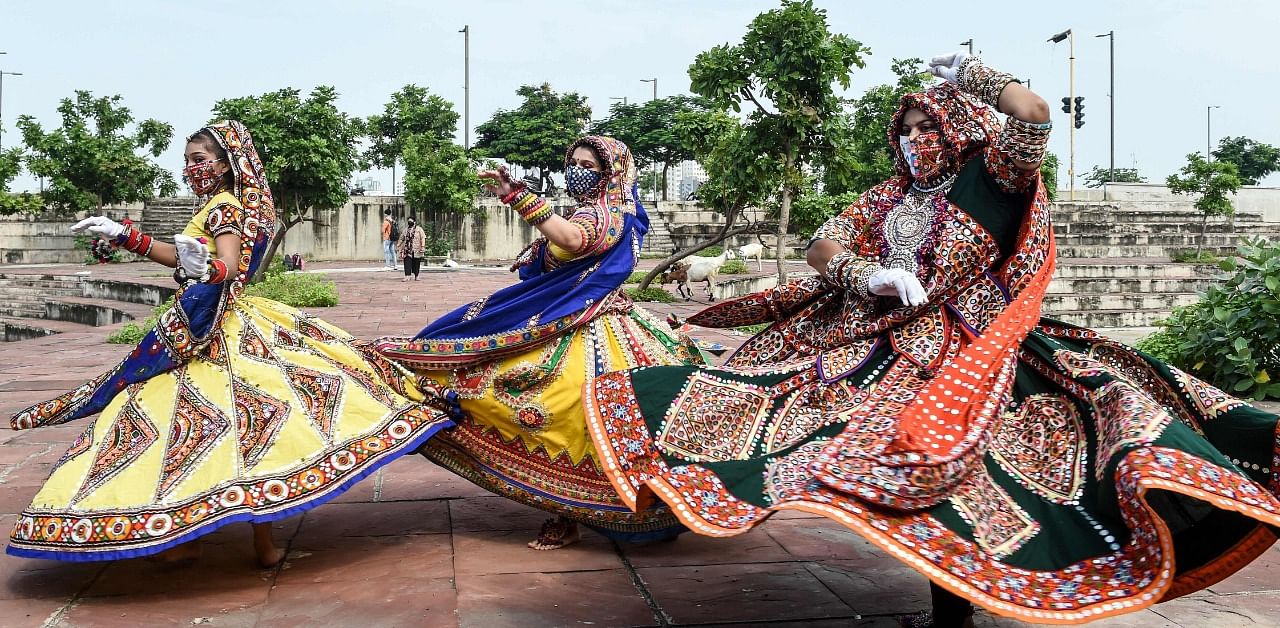 Folk dancers perform while participating in a dress rehearsal ahead of 'Navaratri'. Credit: AFP Photo