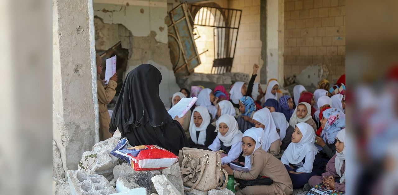 Yemeni pupils attend class on the first day of the new academic year in a makeshift classroom in their school compound, which was heavily damaged two years ago in an air strike. Credit: AFP