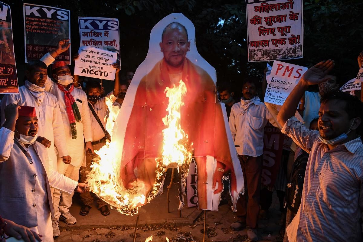 Jawaharlal Nehru University students along with other demonstrators burn an effigy of Chief Minister of Uttar Pradesh Yogi Adityanath during a protest to condemn the alleged gang-rape and murder of a 19-year-old woman in Bool Garhi village of Uttar Prades